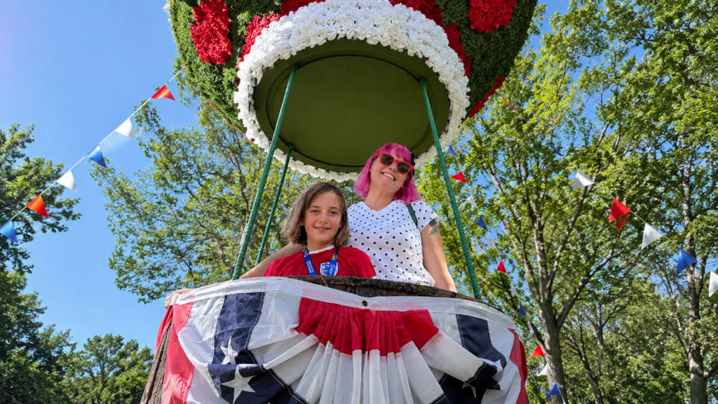 Mandy Florence Mahon smiling with her young daughter while enjoying a colorful outdoor experience together.